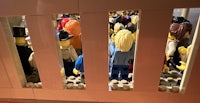 a group of lego people standing in a room